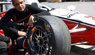 In this photo taken on May 18, 2014, Juan Pablo Montoya, of Colombia, sits next to his car as he waits for his turn to qualify during qualifications for Indianapolis 500 IndyCar auto race at the Indianapolis Motor Speedway in Indianapolis. Montoya needed four races to get comfortable again in an Indy car. His feel has returned just in time for the Indianapolis 500, the race he won in 2000. (AP Photo/Tom Strattman)
