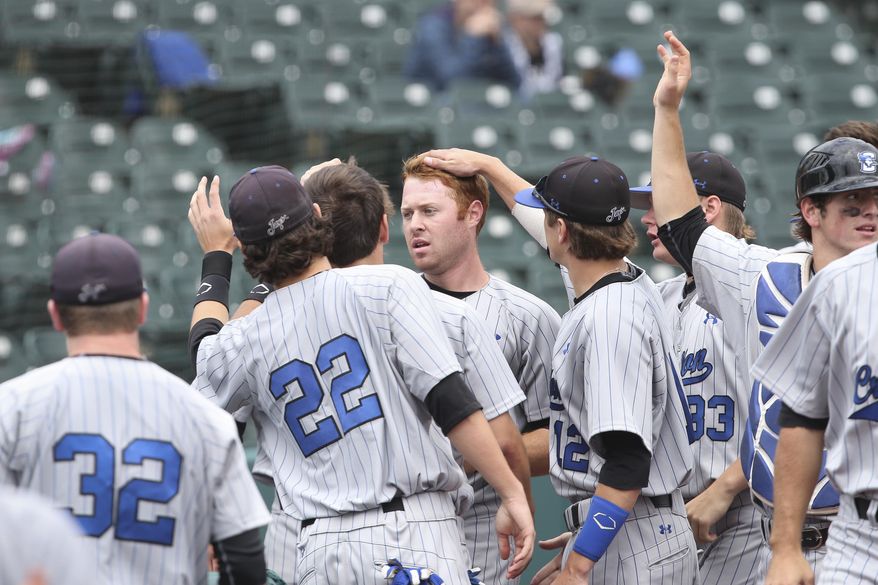 Creighton outfielder Mike Gerber, center, celebrates with his teammates after scoring a run in the third inning of their NCAA college baseball game against Seton Hall in the Big East Conference tournament, Saturday, May 24, 2014, in New York. Creighton won 2-1. (AP Photo/John Minchillo)