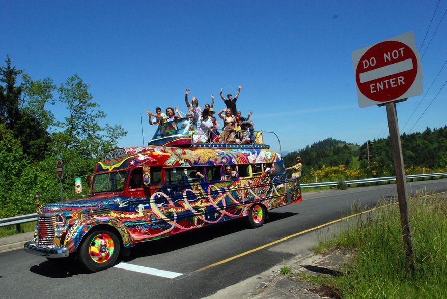 In a May 14, 2014 photo, the reincarnation of author Ken Kesey's psychedelic bus Further stops along a road in Eugene, Ore. Zane Kesey, son of the late author, is on Kickstarter raising money for a cross-country trip commemorating the 1964 LSD-fueled bus trip that became a touchstone of the 1960s. The orginal bus is not road-wrothy, but this newer version bought by Ken Kesey to keep the spirit of the bus alive is still rolling, though in need of repairs. (AP Photo/Jeff Barnard)
