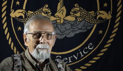 In this May 15, 2014 photo, Paul Wittmer poses for a photo at his home in Manchester, Mo. Wittmer, a submarine veteran from suburban St. Louis who recently turned 90, spent virtually every Tuesday for eight years visiting the National Archives at St. Louis, which houses millions of personnel records from all branches of the military. He compiled biographical information on men lost on submarines during World War II producing a six-volume book. (AP Photo/Jeff Roberson)