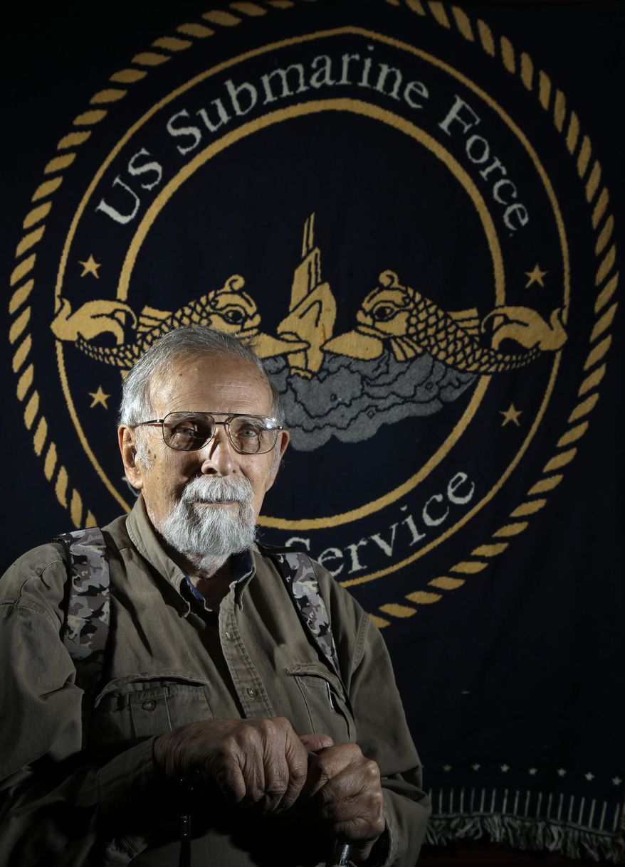In this May 15, 2014 photo, Paul Wittmer poses for a photo at his home in Manchester, Mo. Wittmer, a submarine veteran from suburban St. Louis who recently turned 90, spent virtually every Tuesday for eight years visiting the National Archives at St. Louis, which houses millions of personnel records from all branches of the military. He compiled biographical information on men lost on submarines during World War II producing a six-volume book. (AP Photo/Jeff Roberson)
