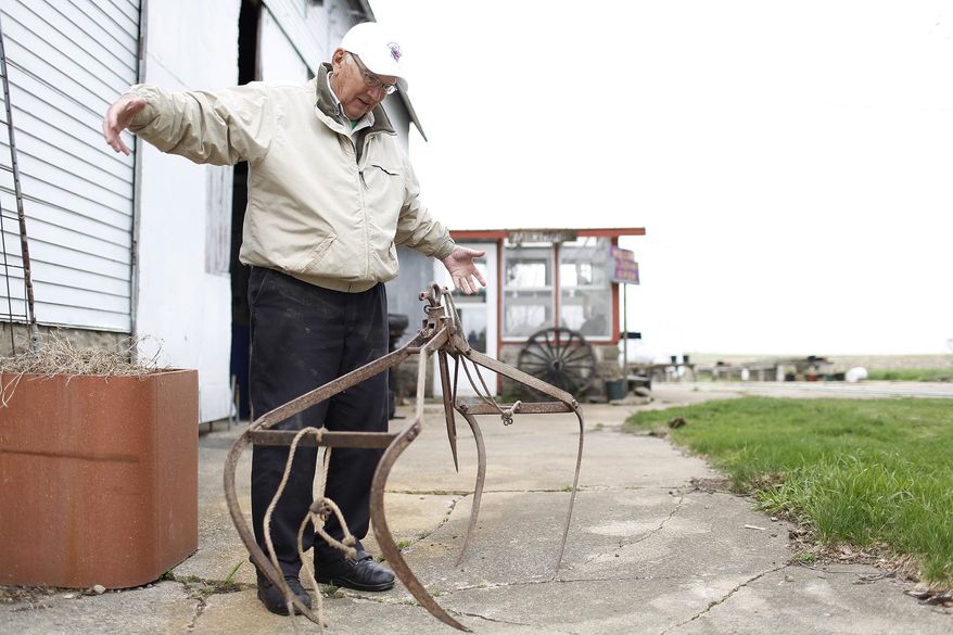 In a Friday, May 9, 2014 photo, Robert Jefferson shows how an old hay fork would work on his Heritage Farm, in Dunkerton, Iowa. Jefferson's Heritage Farm is 158 years old, and one of only 10 in Black Hawk County that have earned the Heritage designation from the Iowa Department of Agriculture and Land Stewardship. (AP Photo/Waterloo Courier, Matthew Putney)