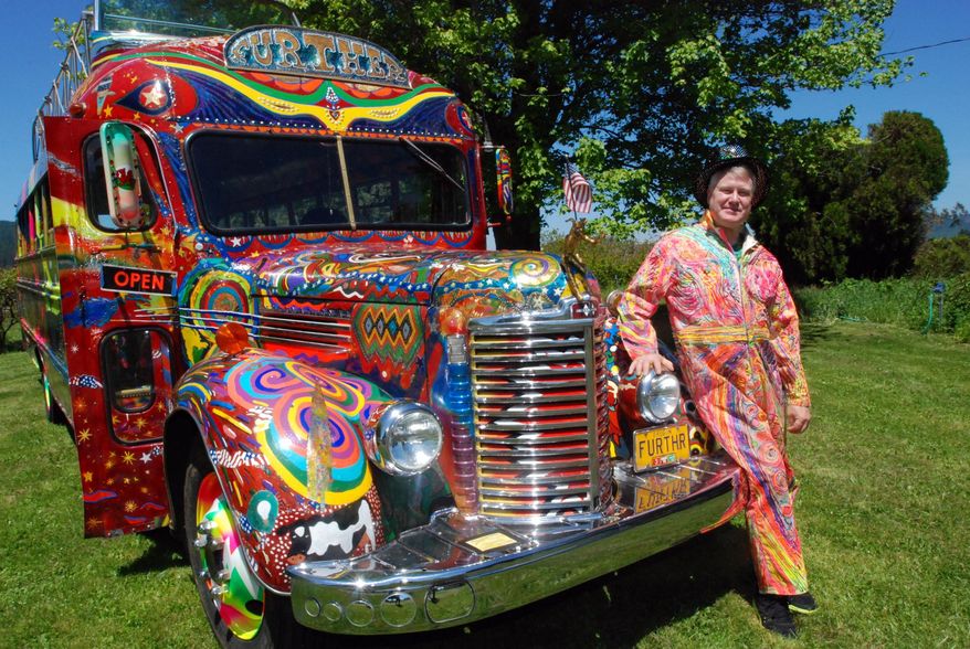 In a May 14, 2014 photo, Zane Kesey poses with the latest version of the psychedelic bus Further in Pleasant Hill, Ore. Kesey is raising money on Kickstarter to put the bus on the road to commemorate the 50th anniversary of the 1964 LSD-fueled bus trip by his late father, author Ken Kesey, and his pals, the Merry Pranksters. (AP Photo/Jeff Barnard) \