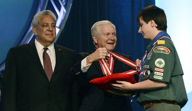 Former Defense Secretary Robert Gates presents Mark Stolowitz with the Silver Buffalo Medal during the Boy Scouts of America&#x27;s annual meeting on Friday, May 23, 2014, in Nashville, Tenn. The Sliver Buffalo Award is the highest commendation given to a volunteer in the Boy Scouts of America. Gates was elected as the organization&#x27;s new president and is taking over one of the nation&#x27;s largest youth organizations as it fights a membership decline and debates its policy toward gays. (AP Photo/Mark Zaleski)