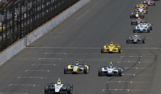 The field, lead by Will Power, of Australia, snakes down the main straightaway during the 98th running of the Indianapolis 500 IndyCar auto race at the Indianapolis Motor Speedway in Indianapolis, Sunday, May 25, 2014. (AP Photo/Darron Cummings)