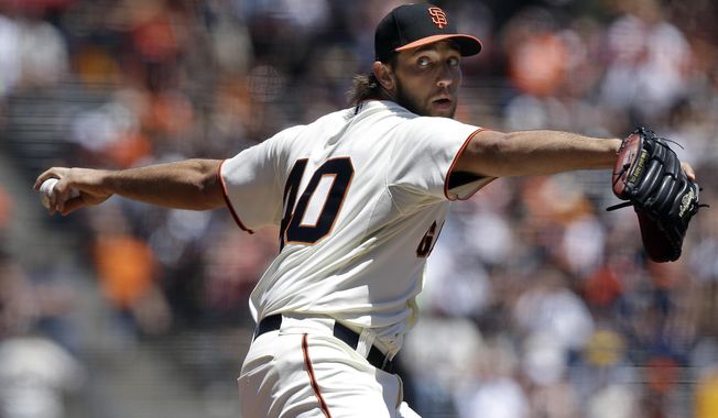 San Francisco Giants pitcher Madison Bumgarner throws against the Minnesota Twins during the first inning of a baseball game in San Francisco, Sunday, May 25, 2014. (AP Photo/Jeff Chiu)