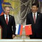 Russia&#39;s President Vladimir Putin and China&#39;s President Xi Jinping smile during a signing ceremony in Shanghai of a long-awaited, 30-year deal to buy Russian natural gas. (Associated Press)