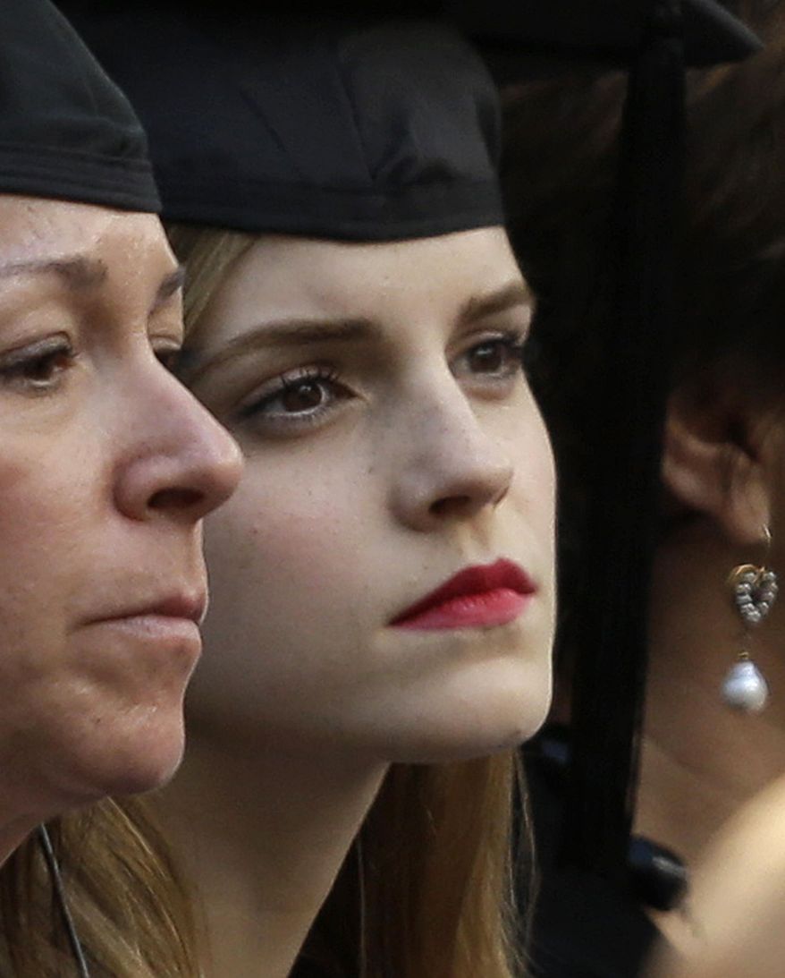 Actress Emma Watson, right, attends commencement services on the campus of Brown University, Sunday, May 25, 2014, in Providence, R.I. The actress, best known for her role as Hermione Granger in the “Harry Potter” movies, is to graduate with a bachelor&#x27;s degree in English literature from the Ivy League university. (AP Photo/Steven Senne)