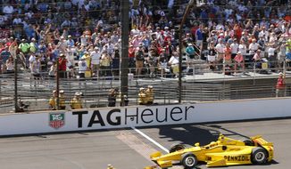 Ryan Hunter-Reay celebrates after crossing the finish line take the checkered flag in front of Helio Castroneves, of Brazil, to win the 98th running of the Indianapolis 500 IndyCar auto race at the Indianapolis Motor Speedway in Indianapolis, Sunday, May 25, 2014. (AP Photo/Dave Parker)