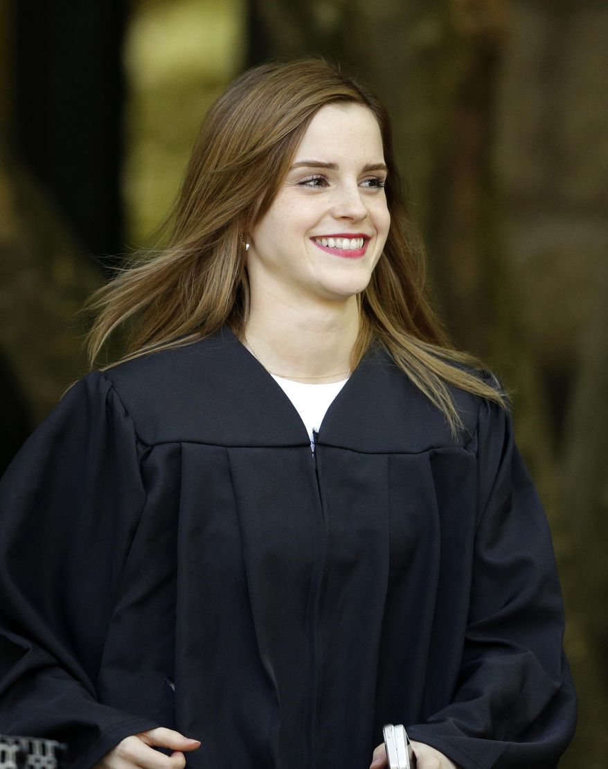 Actress Emma Watson walks between buildings following commencement services on the campus of Brown University, Sunday, May 25, 2014, in Providence, R.I. The actress, best known for her role as Hermione Granger in the “Harry Potter” movies, graduated with a bachelor&#x27;s degree in English literature from the Ivy League university. (AP Photo/Steven Senne)