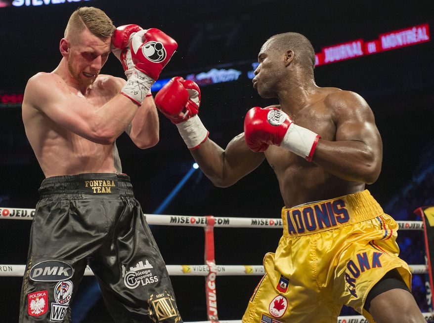 Adonis Stevenson right, and Andrzej Fonfara battle in a WBC light heavyweight title bout in Montreal on Saturday, May 24, 2014. Stevenson successfully defended his World Boxing Council light-heavyweight title Saturday night, unanimously outpointing Poland's Andrej Fonfara. (AP Photo/The Canadian Press, Peter McCabe)