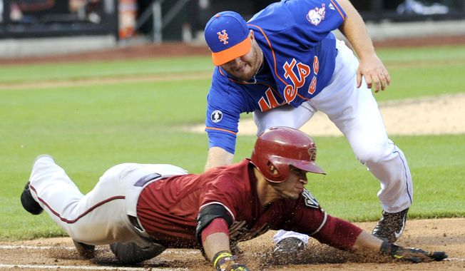 New York Mets pitcher Josh Edgin tags out Arizona Diamondbacks&#x27; Gerardo Parra during the eighth inning of the second game of a baseball double-header at Citi Field, Sunday, May 25, 2014, in New York. (AP Photo/Bill Kostroun)