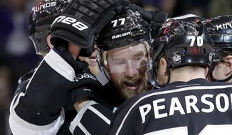 Los Angeles Kings center Jeff Carter (77) celebrates his goal against the Chicago Blackhawks with Tanner Pearson during the second period of Game 3 of the Western Conference finals of the NHL hockey Stanley Cup playoffs in Los Angeles, Saturday, May 24, 2014. (AP Photo/Chris Carlson)