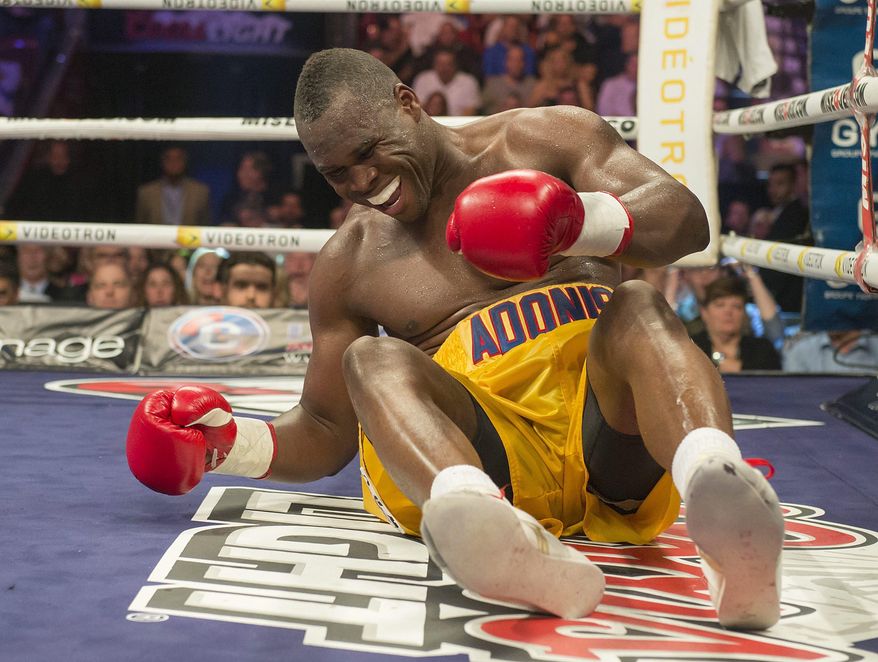 Adonis Stevenson grimaces after going down in the 9th round of his fight with Andrzej Fonfara in a WBC light heavyweight title bout in Montreal on Saturday, May 24, 2014. Stevenson successfully defended his World Boxing Council light-heavyweight title Saturday night, unanimously outpointing Poland's Andrej Fonfara. (AP Photo/The Canadian Press, Peter McCabe)