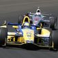 Marco Andretti leads Scott Dixon, of New Zealand, through the first turn during the 98th running of the Indianapolis 500 IndyCar auto race at the Indianapolis Motor Speedway in Indianapolis, Sunday, May 25, 2014. (AP Photo/Tom Strattman)