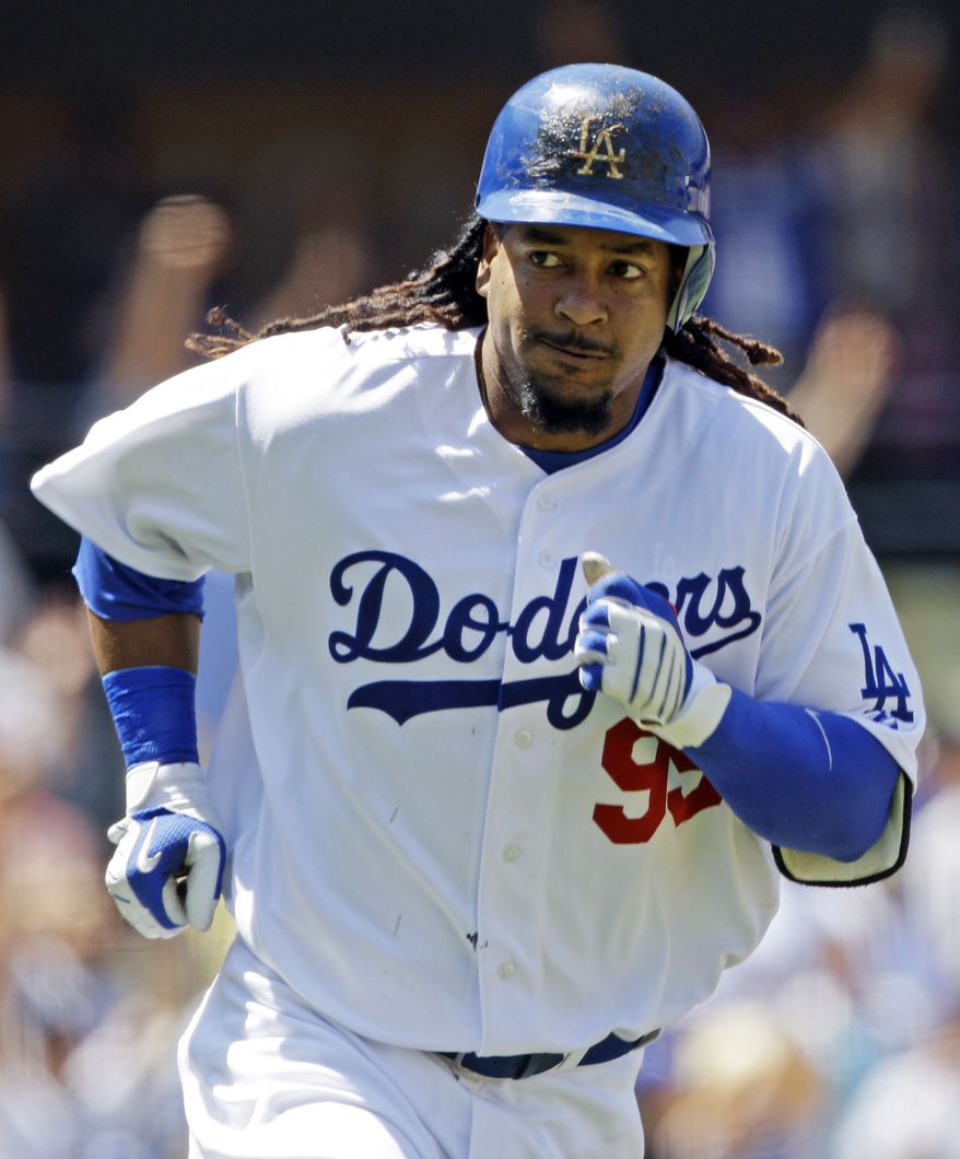File-In this April 18, 2009 file photo, Los Angeles Dodgers' Manny Ramirez looks towards the visitor's dugout as he heads for first on his third-inning home run against the Colorado Rockies in a baseball game in Los Angeles. Ramirez signed a minor league deal with the Cubs on Sunday, May 25, 2014, and will be a player-coach at Triple-A Iowa after he gets some at-bats in extended spring training at the team’s facility in Mesa, Arizona. (AP Photo/Reed Saxon, File)