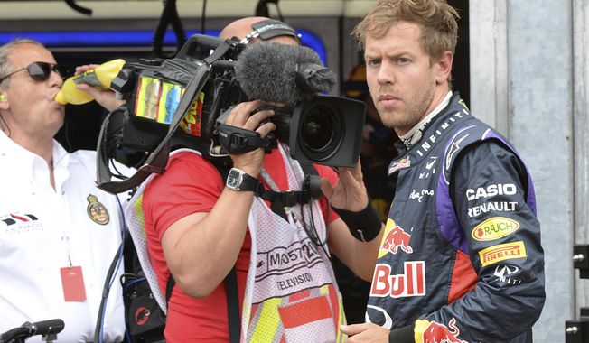 Red Bull driver Sebastian Vettel of Germany watches after he backs to the pits after failing to complete the Monaco Formula One Grand Prix, at the Monaco racetrack, in Monaco, Sunday, May 25, 2014. (AP/hoto/Boris Hovat/ Pool)
