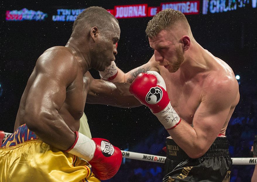 Adonis Stevenson left, and Andrzej Fonfara battle in a WBC light heavyweight title bout in Montreal on Saturday, May 24, 2014. Stevenson successfully defended his World Boxing Council light-heavyweight title Saturday night, unanimously outpointing Poland's Andrej Fonfara. (AP Photo/The Canadian Press, Peter McCabe)