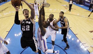 San Antonio Spurs center Tiago Splitter (22) shoots in front of Oklahoma City Thunder forward Serge Ibaka (9) in the first quarter of Game 3 of an NBA basketball playoff series in the Western Conference finals, Sunday, May 25, 2014, in Oklahoma City. (AP Photo/Sue Ogrocki)