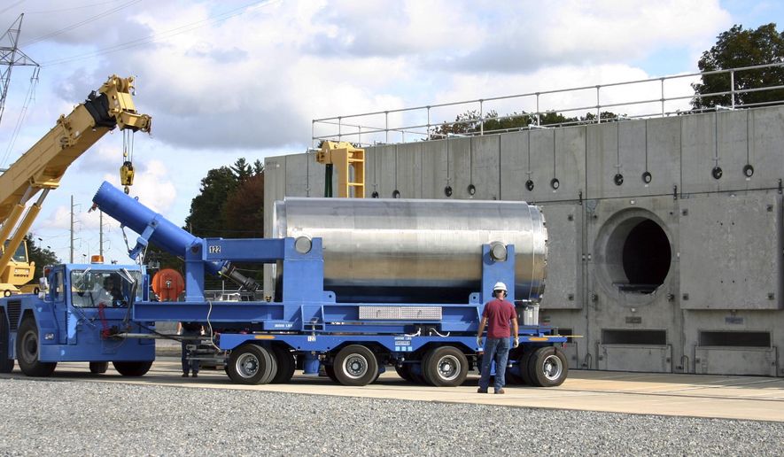 In this Oct. 14, 2010 photo released by Dominion Resources, a trailer holding a spent fuel storage container is maneuvered into position for offloading into a horizontal storage module at the Millstone Power Station in Waterford, Conn. With the collapse of a proposal for nuclear waste storage at Nevada’s Yucca Mountain, Millstone and other plants across the country are building or expanding on-site storage for waste. (AP Photo/Dominion Resources)