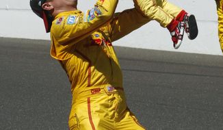 Ryan Hunter-Reay lifts his son, Ryden, after Hunter-Reay won the 98th running of the Indianapolis 500 IndyCar auto race at the Indianapolis Motor Speedway in Indianapolis, Sunday, May 25, 2014. (AP Photo/Tom Strattman)