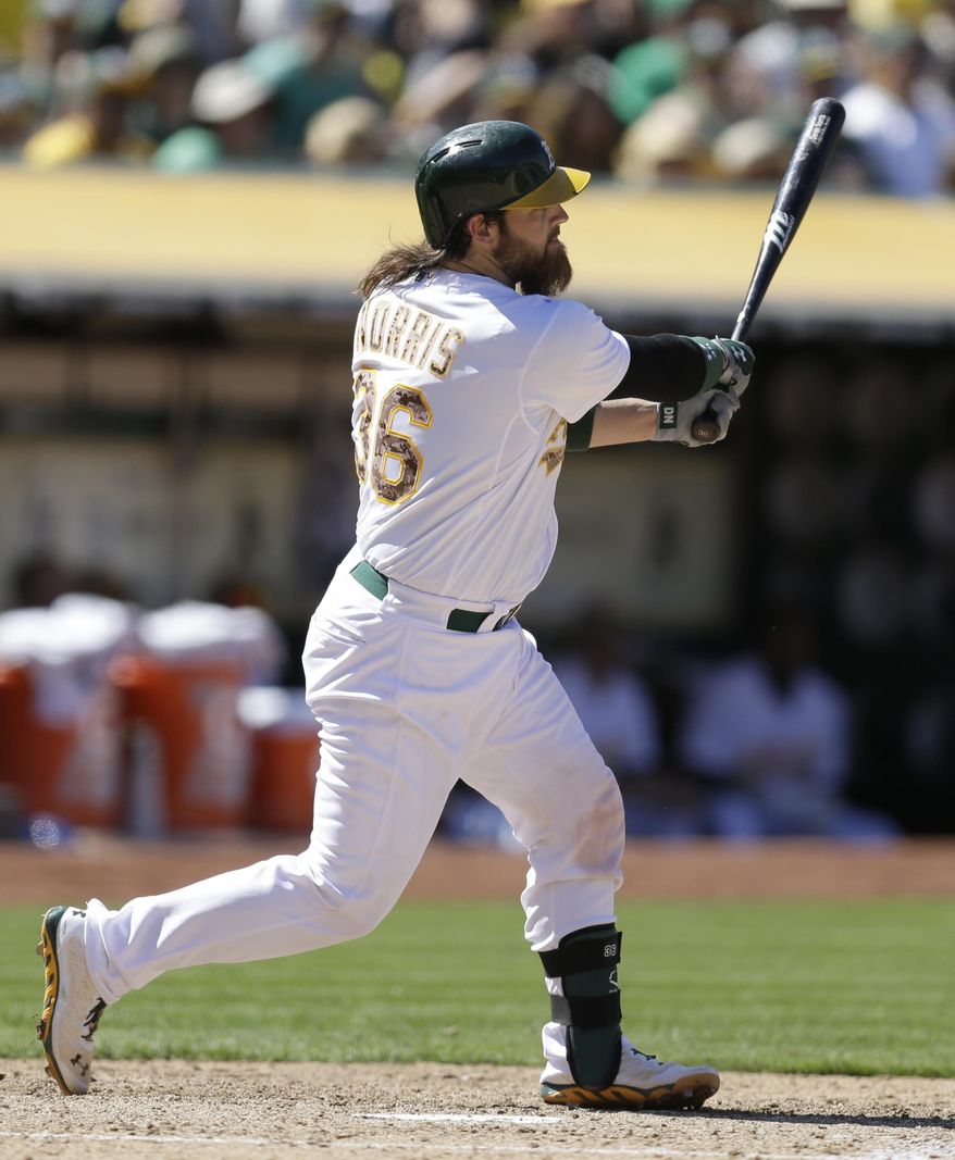 Oakland Athletics&#39; Derek Norris follows through on his swing after hitting a grand slam off Detroit Tigers&#39; Phil Coke in the eighth inning of a baseball game Monday, May 26, 2014, in Oakland, Calif. (AP Photo/Ben Margot)