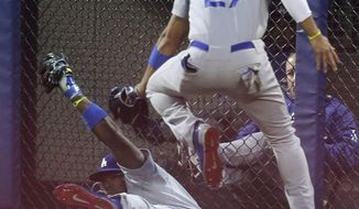 Los Angeles Dodgers center fielder Matt Kemp (27) leaps over right fielder Yasiel Puig (66) as Puig holds up a diving catch on a ball hit by New York Mets&#39; Wilmer Flores during the second inning of a baseball game, Thursday, May 22, 2014, in New York. (AP Photo/Julie Jacobson)