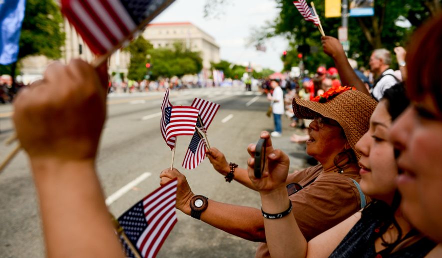 Visitors line the sidewalk along Constitution Avenue to watch the National Memorial Day Parade in Washington, D.C., Monday, May 26, 2014. (Andrew Harnik/The Washington Times) ** FILE **