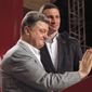 Ukrainian presidential candidate Petro Poroshenko, left, and Vitali Klitschko, pause, during a press conference, in Kiev, Ukraine, Monday, May 26, 2014. (AP Photo/Efrem Lukatsky)