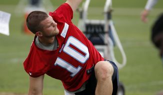 Tennessee Titans quarterback Jake Locker stretches during NFL football minicamp, Tuesday, May 27, 2014, in Nashville, Tenn. Locker is back on the field with the Titan--a couple of weeks ahead of the schedule doctors estimated for his return from an injured right foot. (AP Photo/Mark Humphrey)