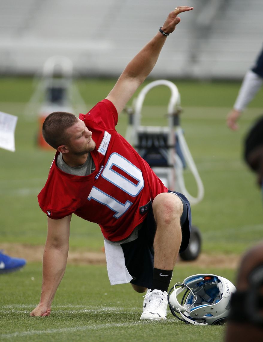 Tennessee Titans quarterback Jake Locker stretches during NFL football minicamp, Tuesday, May 27, 2014, in Nashville, Tenn. Locker is back on the field with the Titan--a couple of weeks ahead of the schedule doctors estimated for his return from an injured right foot. (AP Photo/Mark Humphrey)
