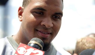 Miami Dolphins&#39; Mike Pouncey talks to the media after an organized team activity Tuesday, May 27, 2014, in Davie, Fla. Pouncey claims to have no regrets about last season&#39;s incidents in a bullying scandal in which an NFL-sanctioned investigator identified him and two teammates as principals involved. ( AP Photo/J Pat Carter)