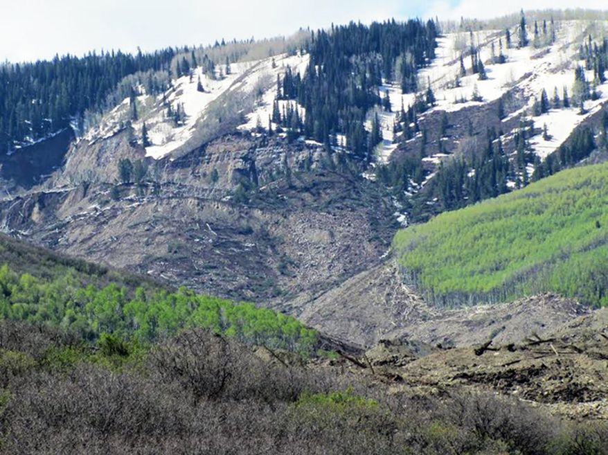 The results of a three-mile long mudslide appear on Grand Mesa, where the slide started, in a remote part of western Colorado near the small town of Collbran Monday, May 26, 2014. Rescue teams are searching for three men missing after a half-mile stretch of a ridge saturated with rain collapsed.(AP Photo/Mesa County Sheriff's Office)