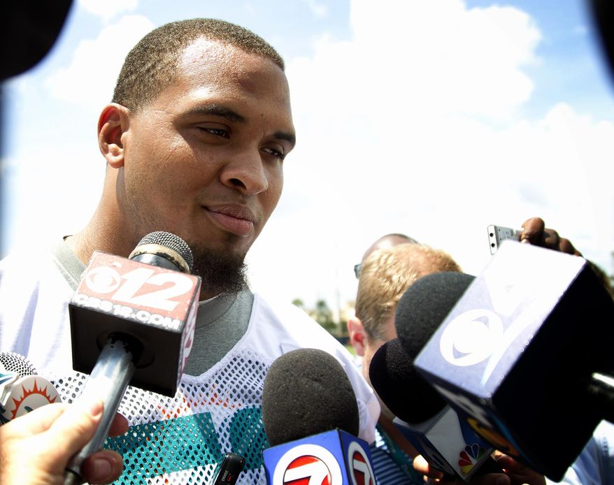 Miami Dolphins' Mike Pouncey talks to the media after an organized team activity Tuesday, May 27, 2014, in Davie, Fla. Pouncey claims to have no regrets about last season's incidents in a bullying scandal in which an NFL-sanctioned investigator identified him and two teammates as principals involved. ( AP Photo/J Pat Carter)