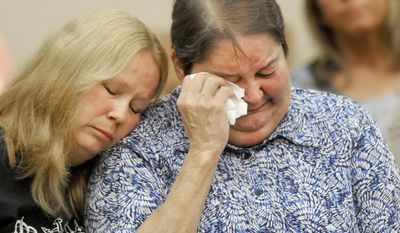 Dustyn Frolka's aunt Lisa Frolka, left, comforts his mother Eileen Hincka before Samantha Grigg is sentenced in Clinton County Circuit Court Tuesday, May 27, 2014,in St. John's Mich. Grigg, an 18-year-old high school senior who drove a vehicle involved in the death Michigan State University student Dustyn Frolka, 19, was sentenced Tuesday to 6 to 15 years in prison for manslaughter and unarmed robbery. (AP Photo/The State Journal, Greg DeRuiter)  NO SALES