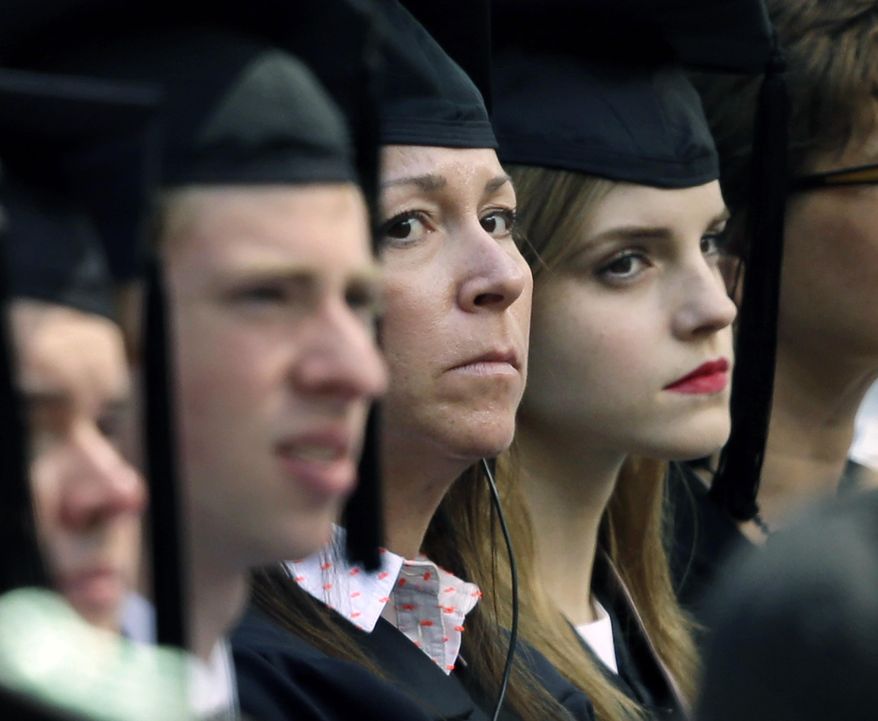 In this Sunday, May 25, 2014 photo, actress Emma Watson, right, sits beside a woman, left, later seen wearing a badge and with a handgun visible at her side, during commencement services at Brown University in Providence, R.I.  A Brown spokesman said Tuesday, May 27, 2014, he was unable to answer questions about why the British actress had the undercover armed guard sitting with her during graduation ceremonies. (AP Photo/Steven Senne)