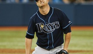 Tampa Bay Rays&#39; Alex Cobb reacts after getting hit by a ball from Toronto Blue Jays&#39; Jose Reyes during the fifth inning of a baseball game in Toronto on Tuesday, May 27, 2014. (AP Photo/The Canadian Press, Aaron Vincent Elkaim)