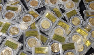 FILE - This Feb. 25, 2014 file photo shows some of the 1,427 Gold-Rush era U.S. gold coins displayed at Professional Coin Grading Service in Santa Ana, Calif. A treasure trove of rare gold coins discovered by a California couple out walking their dog is set to go on sale on Tuesday, May 27, 2014.  (AP Photo/Reed Saxon, File)
