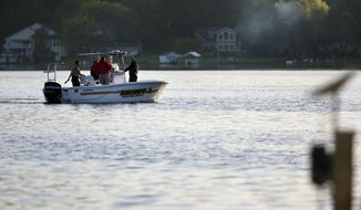 In this photo taken on Sunday, May 25, 2014, the Newaygo County Sheriff Department searches for a woman in Kimball Lake in Garfield Township near Newaygo, Mich. Witnesses say she had been on a pontoon boat with a group when she disappeared while swimming  The woman was not believed to be wearing a life jacket at the time she disappeared. (Lauren Petracca | MLive.com)