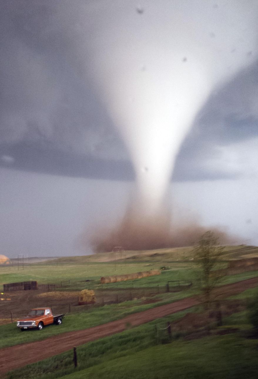This photo taken on Monday, May 26, 2014 and provided by Jill Helmuth, shows a tornado touching down on a reach before heading towards Watford City, N.D. Authorities say several were injured and more than a dozen trailers were damaged or destroyed Monday evening when the twister tore through a camp where oil field workers stay. (AP Photo/Jill Helmuth)