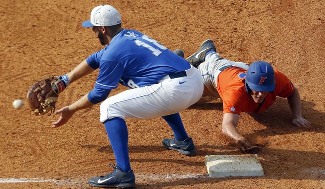 Florida&#x27;s Harrison Bader beats the throw to Kentucky&#x27;s A.J. Reed (18) as he dives back to first base during the fifth inning at the Southeastern Conference NCAA college baseball tournament Saturday, May 24, 2014, in Hoover, Ala. (AP Photo/Butch Dill)