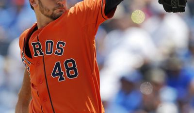 Houston Astros starting pitcher Jarred Cosart delivers to a Kansas City Royals batter during the first inning of a baseball game at Kauffman Stadium in Kansas City, Mo., Wednesday, May 28, 2014. (AP Photo/Orlin Wagner)