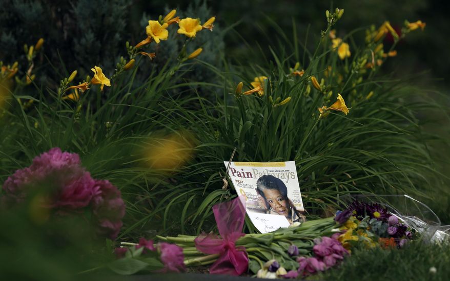 A memorial is shown outside a gate at the home of Maya Angelou in Winston-Salem, N.C., Wednesday, May 28, 2014. Angelou, a Renaissance woman and cultural pioneer, died Wake Forest University said in a statement Wednesday, May 28, 2014. She was 86. (AP Photo/Gerry Broome)