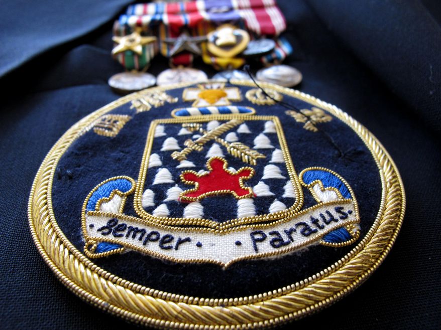 ADVANCE FOR USE MONDAY, JUNE 2, 2014, AND THEREAFTER - This April 2, 2014, photo shows a 16th Infantry Regiment patch with the Latin motto "Always Prepared" that decorates Ray Lambert's blazer at his home in Seven Lakes, N.C. Of the 31 men in the landing craft he rode onto Omaha Beach on D-Day, only seven made it ashore, and four of those, included Lambert, were wounded. (AP Photo/Allen G. Breed)