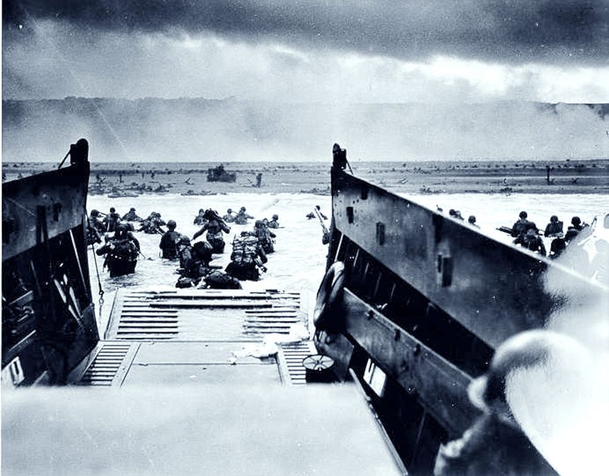 "The Jaws of Death." A photo by CPHOM Robert F. Sargent, USCG. A Coast Guard-manned LCVP from the U.S.S. Samuel Chase disembarks troops of the First Division on the morning of 6 June 1944 at Omaha Beach. USCG Photo.