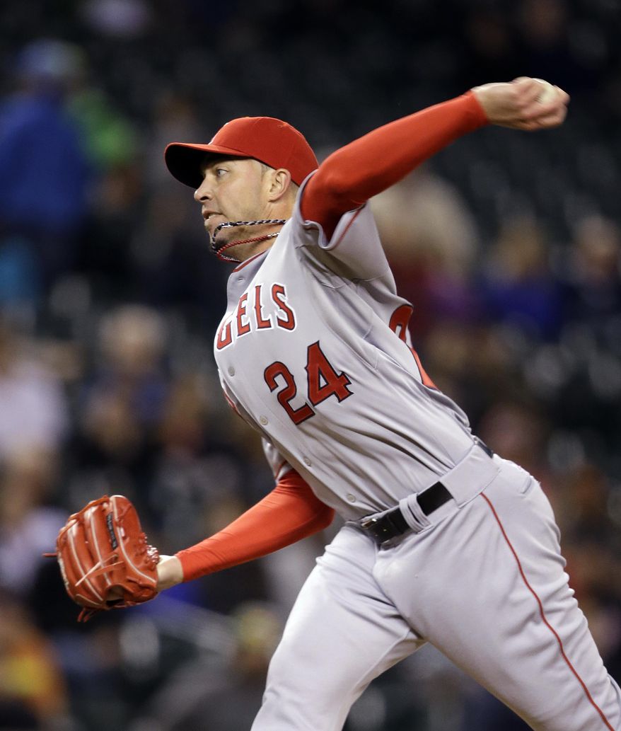 Los Angeles Angels relief pitcher Sean Burnett throws against the Seattle Mariners in the seventh inning of a baseball game Tuesday, May 27, 2014, in Seattle. Burnett left the game moments later with an apparent injury. (AP Photo/Elaine Thompson)