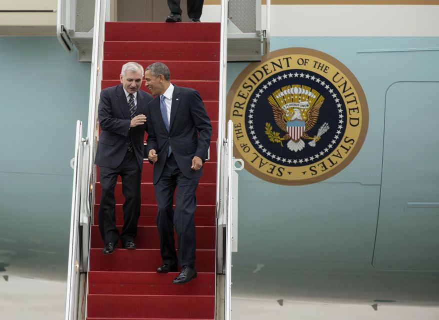 President Barack Obama and Senate Armed Service Committee member Sen. Jack Reed, D-R.I., laugh as they walk down the steps from Air Force One, upon their arrival at the Stewart Air National Guard Base in Newburgh, N.Y., Wednesday, May 28, 2014, before heading to the United States Military Academy at West Point where the president was to deliver the commencement address. (AP Photo/Philip Kamrass)