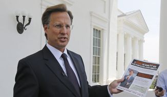 Seventh District US Congressional Republican candidate, David Brat displays an immigration mailer by Congressman Eric Cantor during a press conference at the Capitol in Richmond, Va., Wednesday, May 28, 2014. Brat challenged Congressman Eric Cantor&#39;s stand on immigration, claiming that Cantor backs amnesty. Cantor is getting pressured from both sides over immigration as his Republican primary election nears and the window for legislative action narrows.   (AP Photo/Steve Helber)