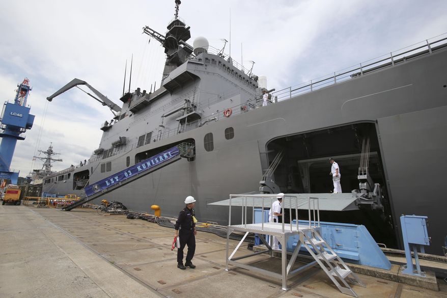 In this Tuesday, May 27, 2014 photo, the Japan Maritime Self-Defense Force tank landing ship JS Kunisaki is anchored in Yokosuka near Tokyo, getting ready for participating in the Pacific Partnership 2014. China’s moves to assert its territorial claims in the South China Sea are giving fresh impetus to a Japanese push to play a bigger role in regional security, adding to the growing strains between the two Asian rivals. Japan is playing a larger role in a U.S.-led disaster relief exercise in Southeast Asia. The Kunisaki, is the lead vessel for the exercise for the first time. It departed the U.S. naval base in Yokosuka on Thursday, May 29, with 10 Australian and 130 U.S. troops aboard, headed for Vietnam, the Philippines and Cambodia. (AP Photo/Koji Sasahara)