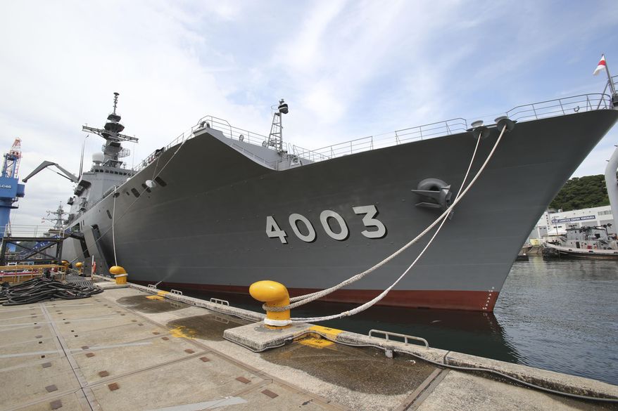 In this Tuesday, May 27, 2014 photo, the Japan Maritime Self-Defense Force tank landing ship JS Kunisaki is anchored in Yokosuka near Tokyo, getting ready for participating in the Pacific Partnership 2014. China’s moves to assert its territorial claims in the South China Sea are giving fresh impetus to a Japanese push to play a bigger role in regional security, adding to the growing strains between the two Asian rivals. Japan is playing a larger role in a U.S.-led disaster relief exercise in Southeast Asia. The Kunisaki, is the lead vessel for the exercise for the first time. It departed the U.S. naval base in Yokosuka on Thursday, May 29, with 10 Australian and 130 U.S. troops aboard, headed for Vietnam, the Philippines and Cambodia. (AP Photo/Koji Sasahara)